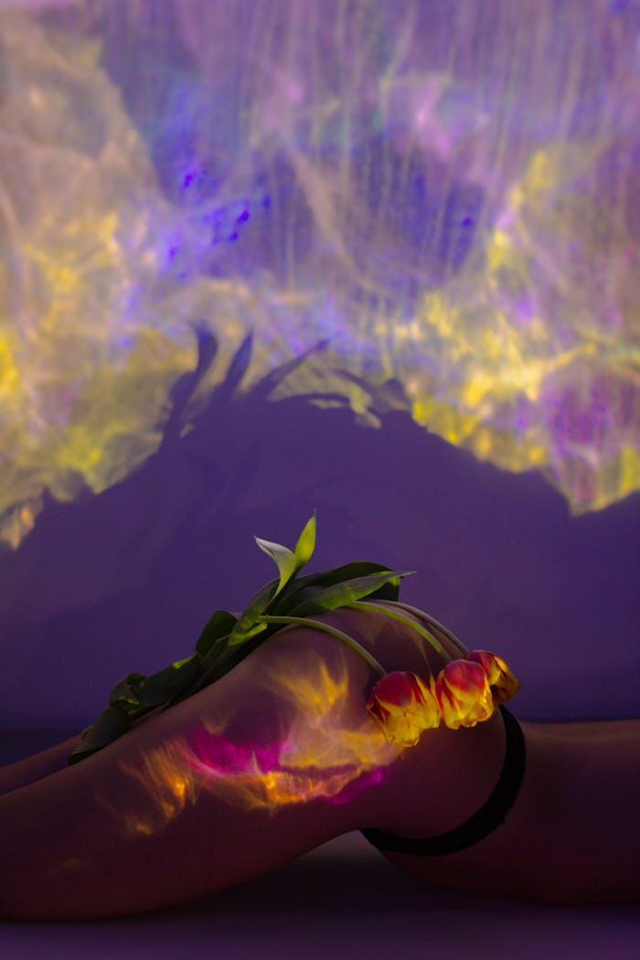 Artistic projection of colorful tulips on a human form creating a vibrant romantic visual.